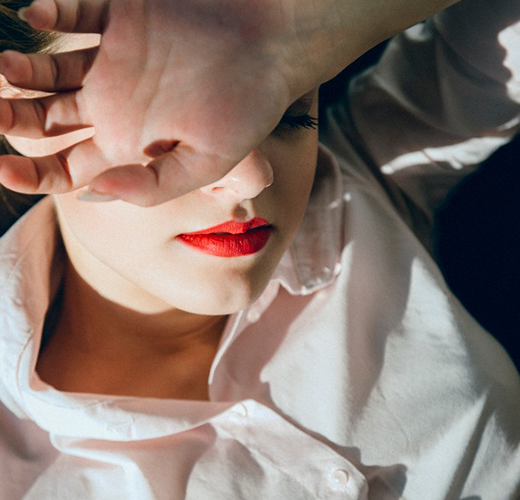 Women lying down with her hand over her face