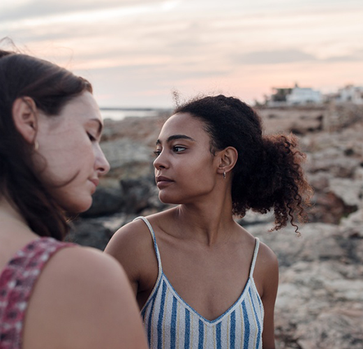 Two women outdoors during the sunset