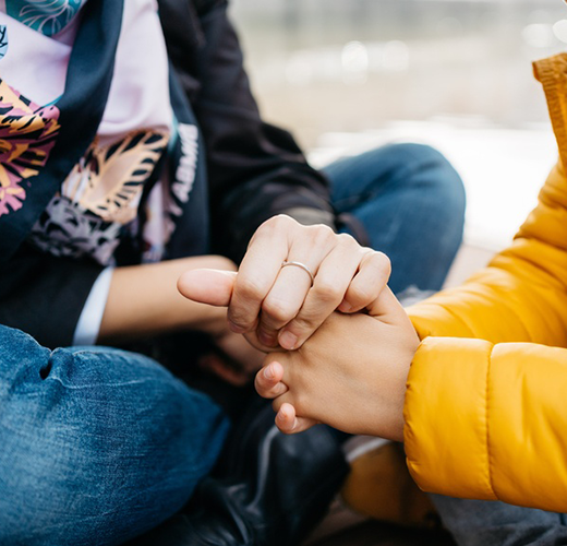 Mother holding her child's hand